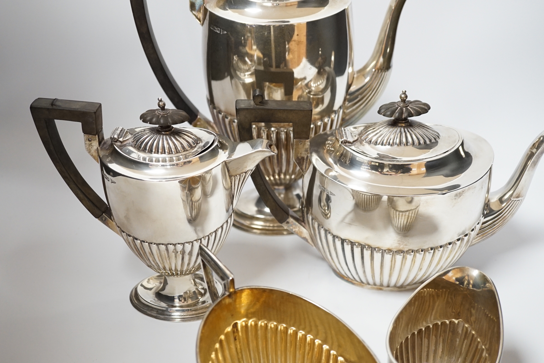 An Edwardian matched demi fluted silver five piece tea and coffee service, by Walker & Hall, Chester, 1906 and Sheffield, 1907/1908, the coffee pot and hot water jug with pedestal foot, gross weight 79.3oz.